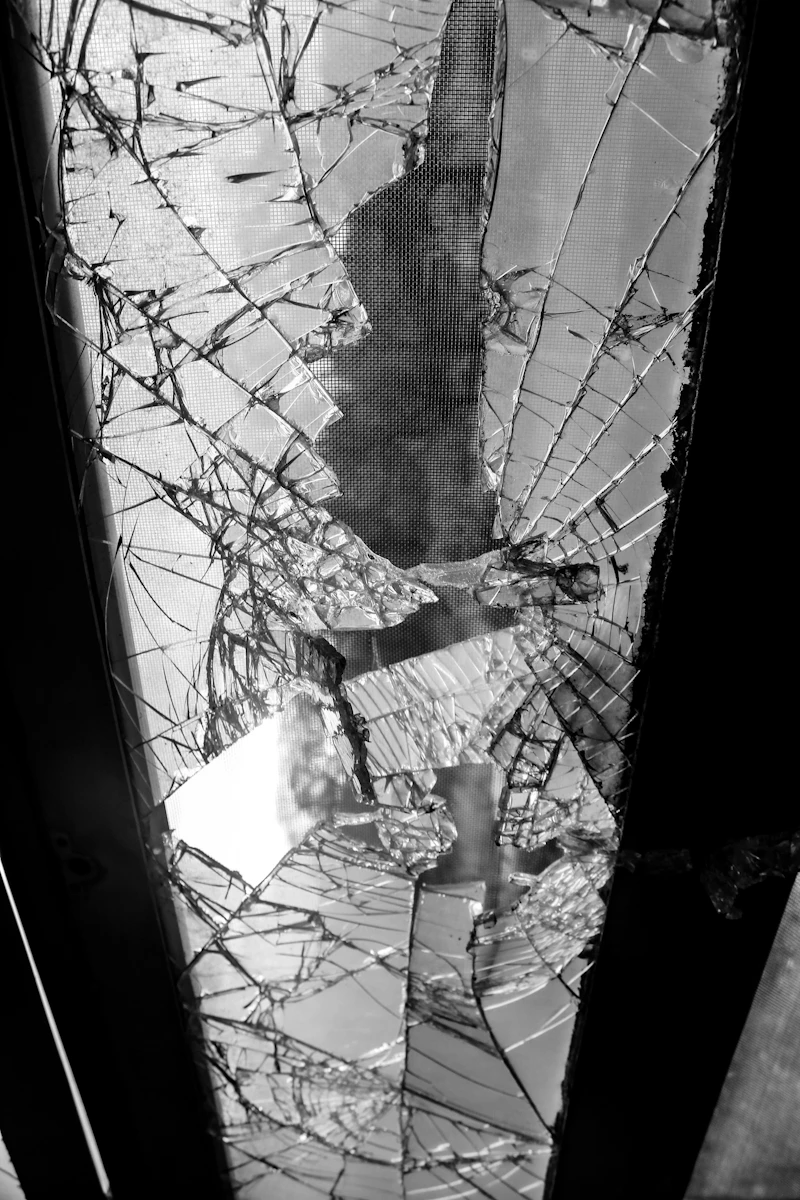 Shattered glass fragments with dramatic dark lighting