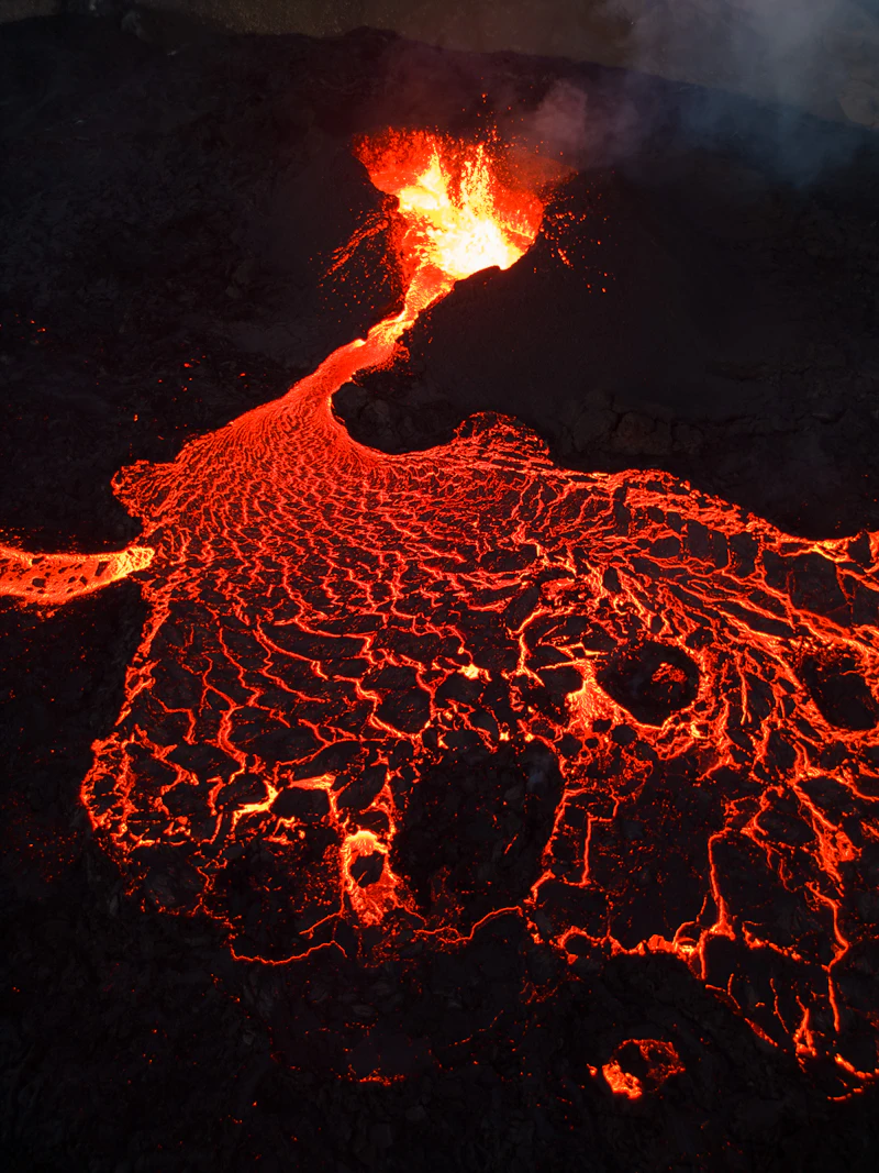 Molten lava flow glowing orange against dark terrain
